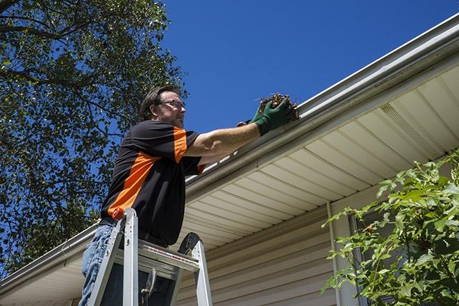 gutter repairman fixing a leaky drain in Alviso